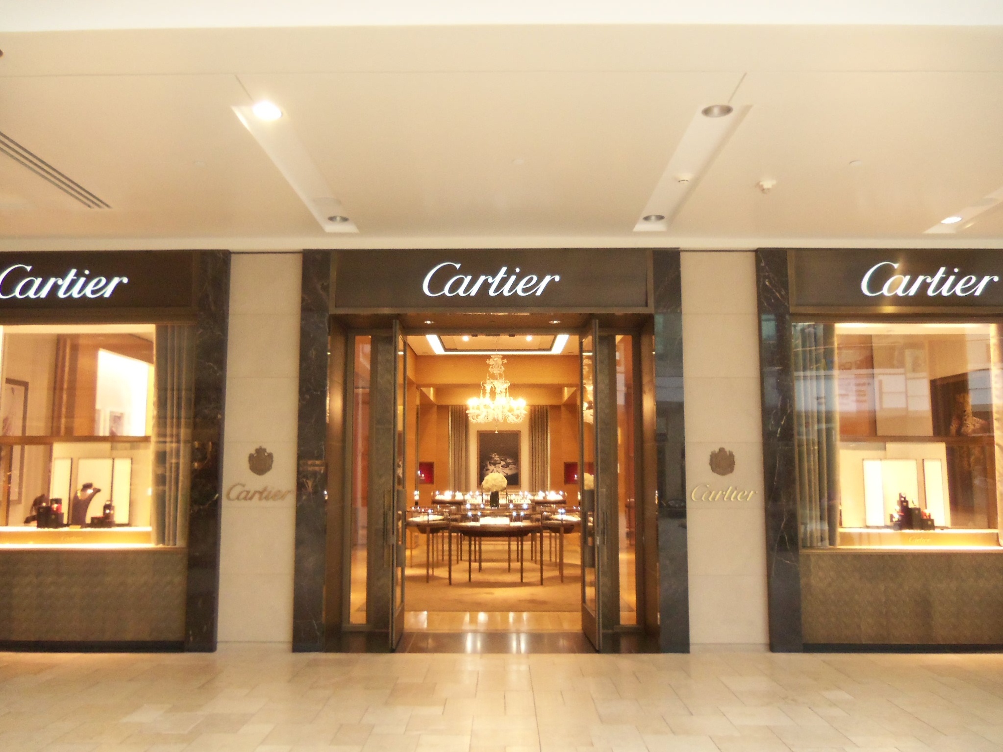 an entrance to a fancy store decorated in chandelier