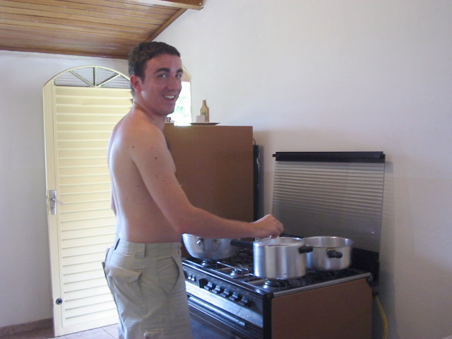 a man in  cooking food on top of an oven
