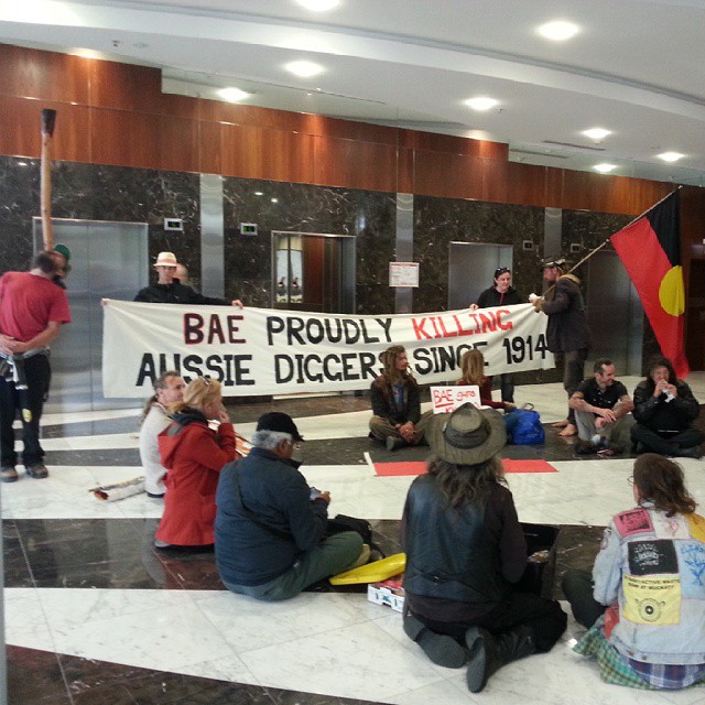 people sitting on the floor holding signs and signs