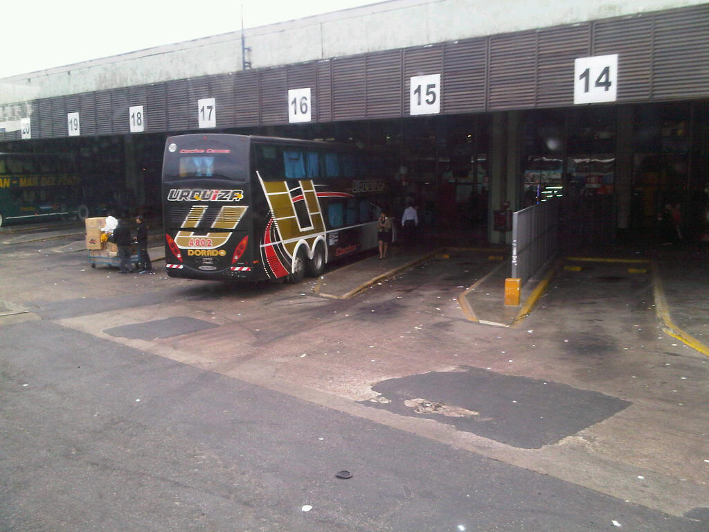 a bus parked under a building at a station