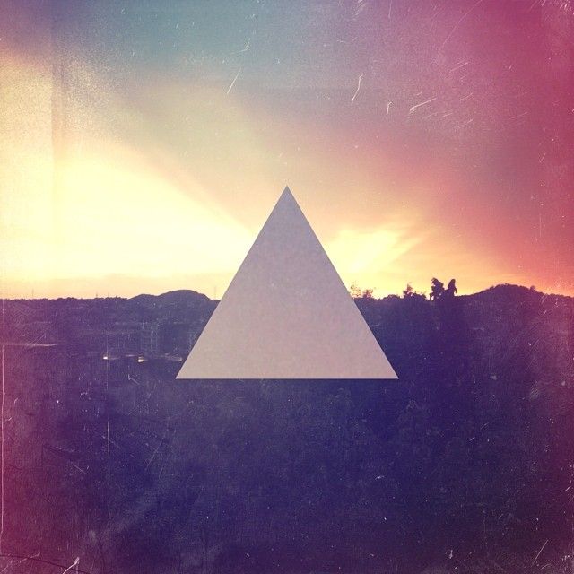 a picture of a triangle with the sun in the background