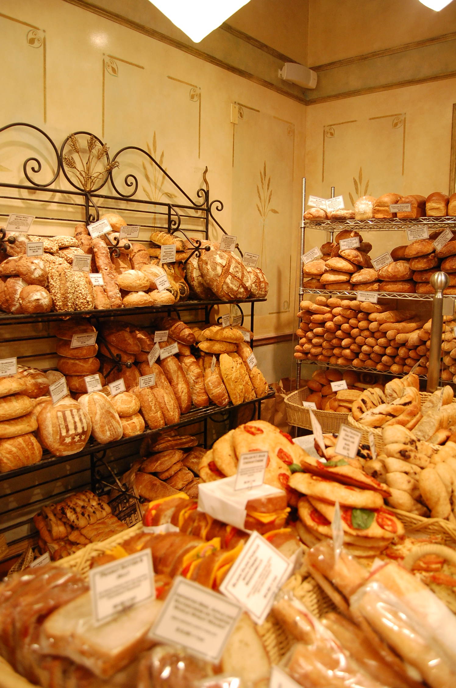 bread and pastries displayed on display in an indoor market