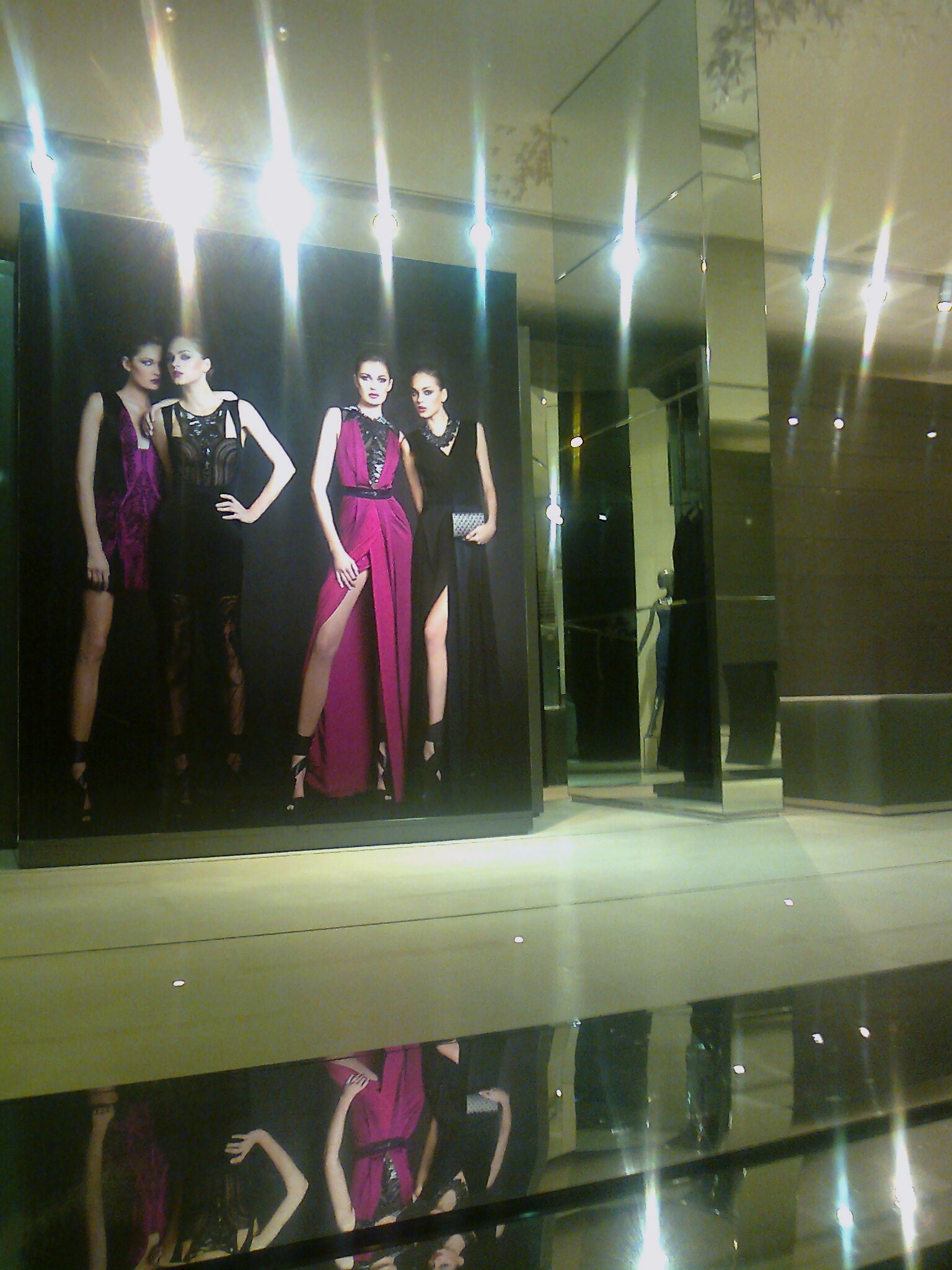 a display window with three mannequins displayed in front of the display
