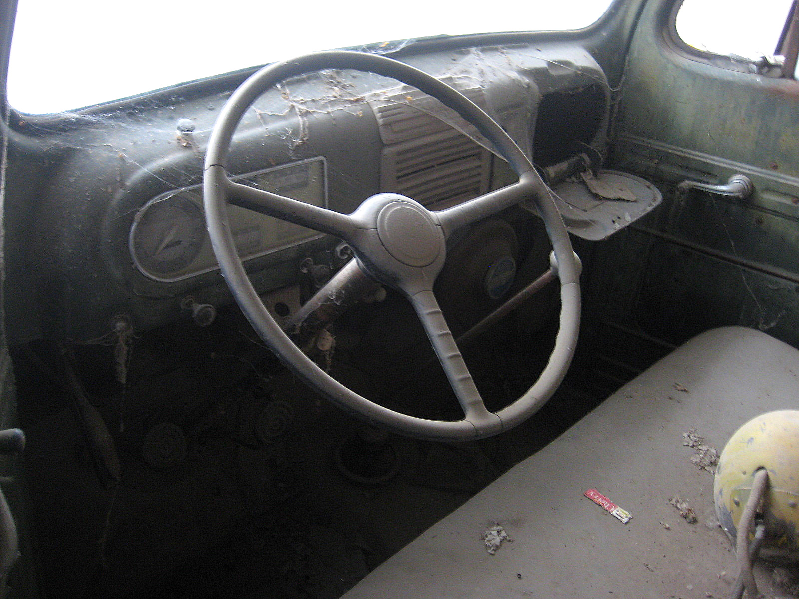 an old truck steering wheel and dash board