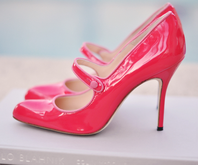 a pink shoe with scalloped,  toes