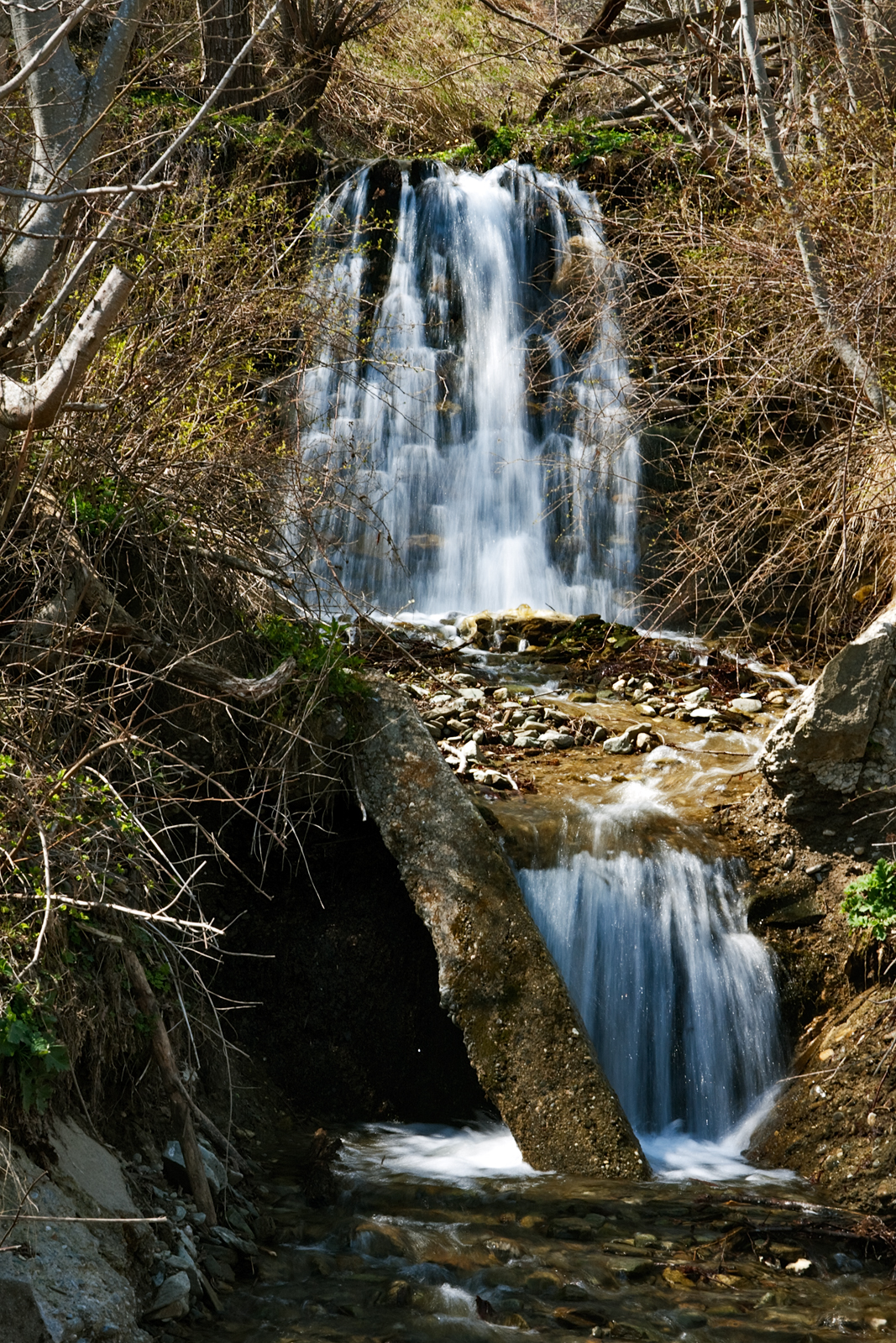 a waterfall that has a rock ledge below it