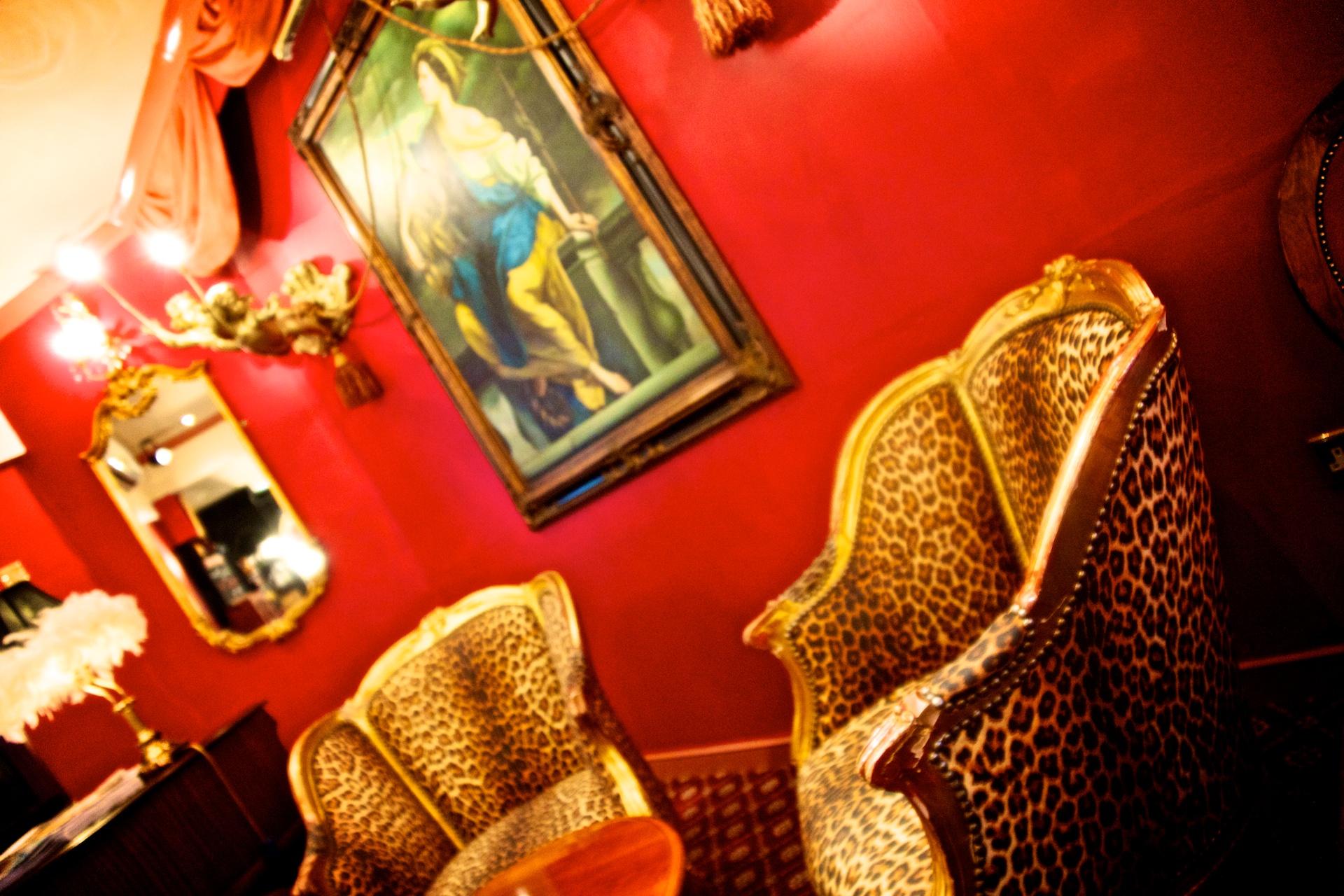 a red room with several upholstered chairs