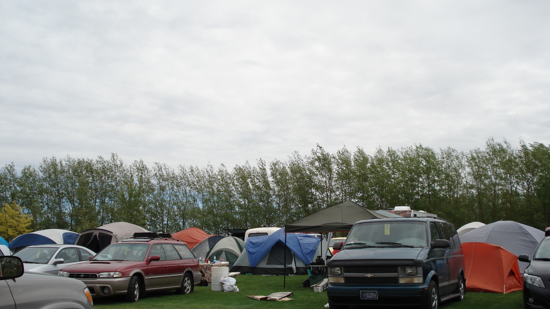 parked campers have been camping in a grassy field