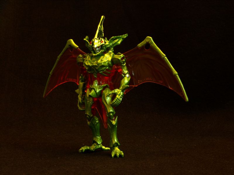 a close - up of the red dragon figurine is standing upright