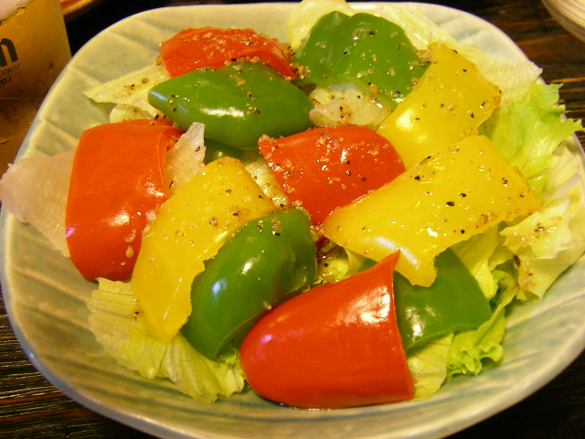 a plastic plate filled with salad and vegetables