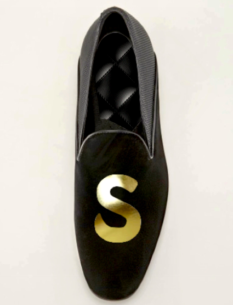 black, golden shoe with the word s on it