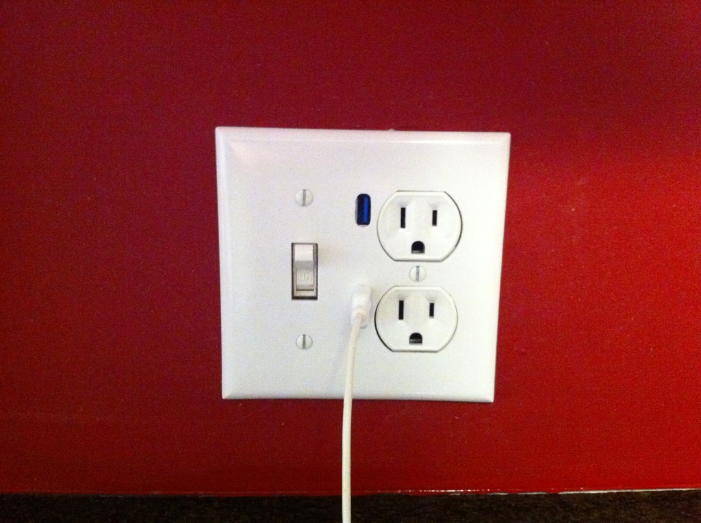 a white outlet plug attached to an electrical outlet