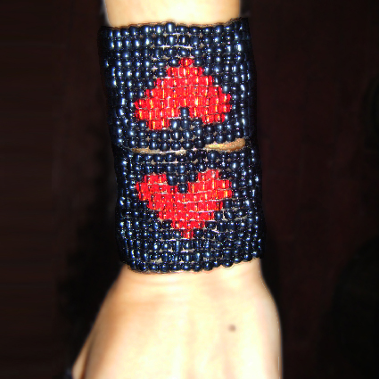 a woman's hand has beaded celets on it