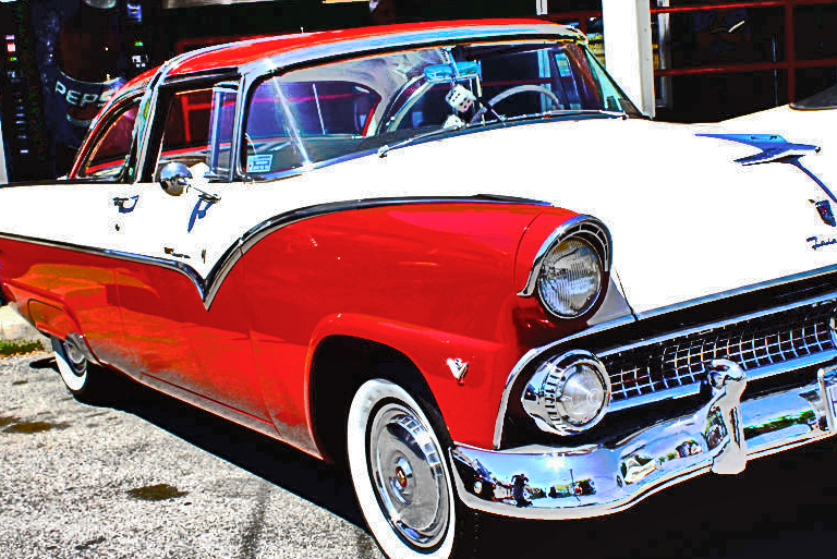 the vintage car is painted red and white