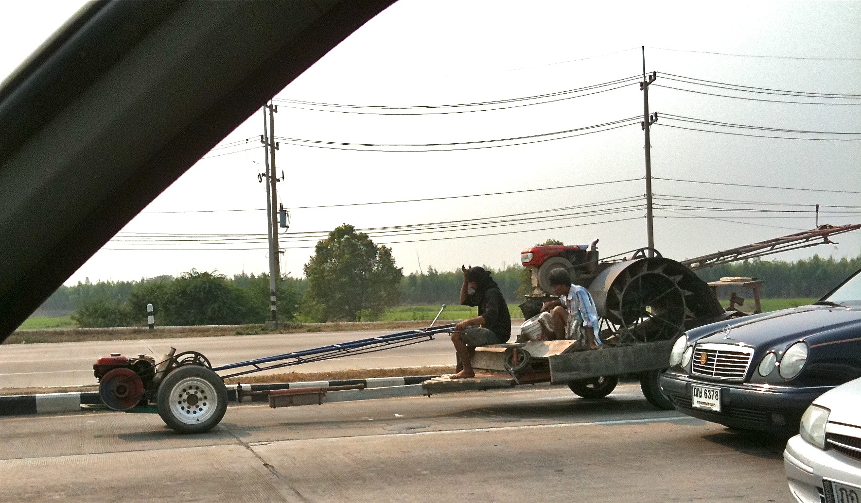 there is a car pulling a trailer on a flatbed