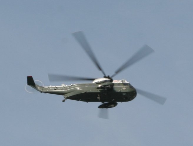 a helicopter with propellers flying in the air