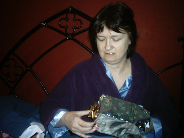 a woman holding a small gift on her lap