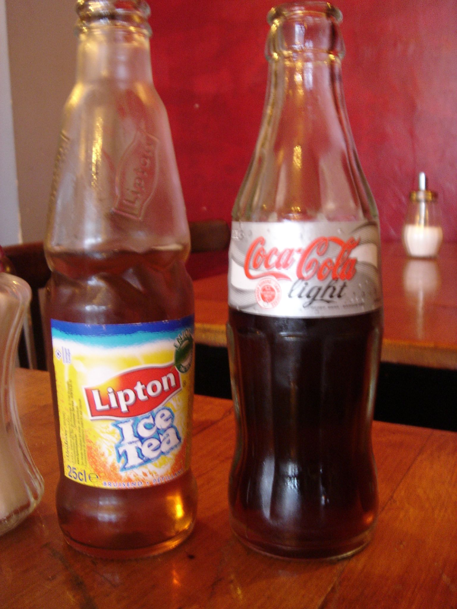 two bottles of cola on top of a table