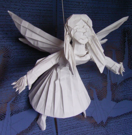 a paper angel with its wings opened and stringed together