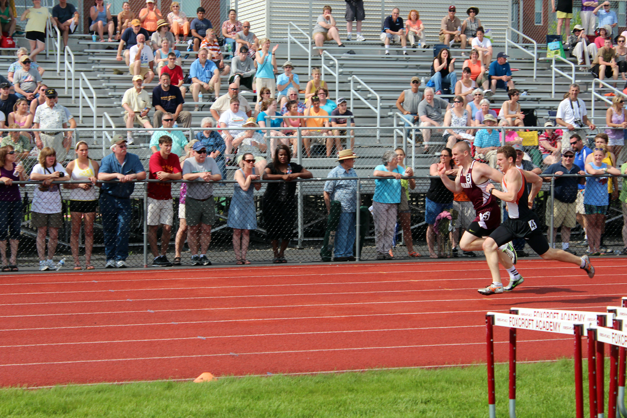 a guy is racing across the track during a race