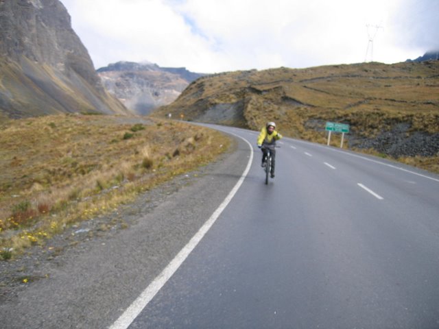 a man riding a bicycle down the middle of a road