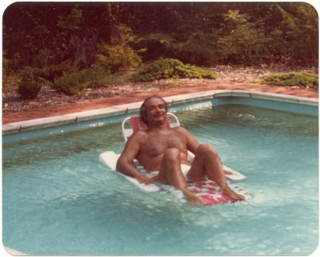 a person laying on a white surfboard in a pool