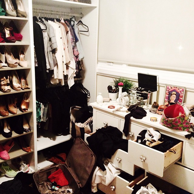 a white cabinet with drawers and many shoes in it