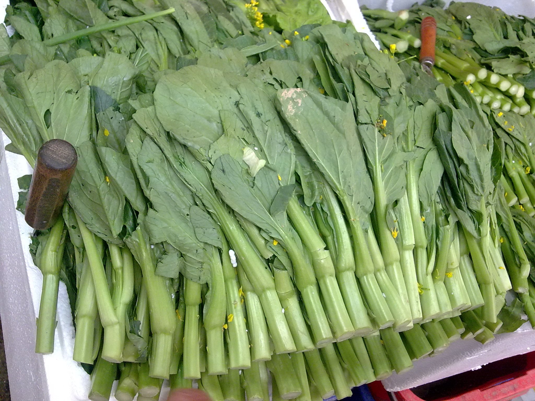 some veggies laying on top of each other and ready to be purchased