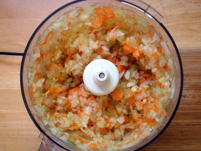 a food processor is full of chopped vegetables