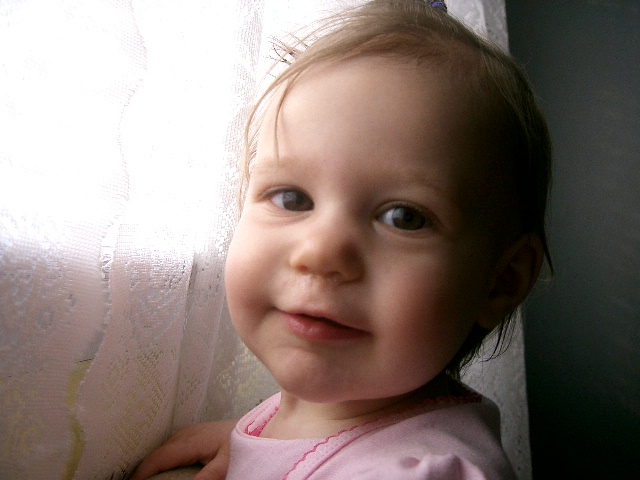a close up of a child near a window