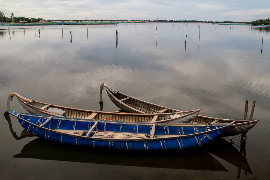 three empty boats that are floating in the water