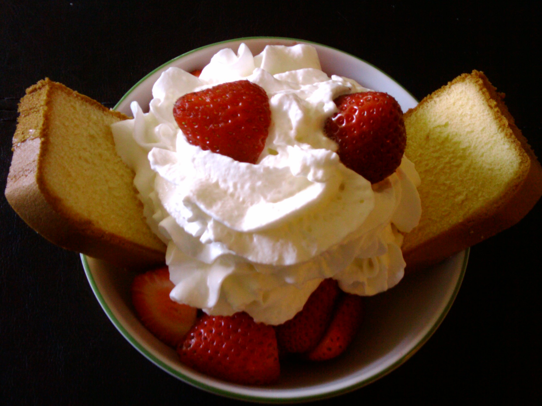 a white plate filled with sliced slices of bread covered in whipped cream