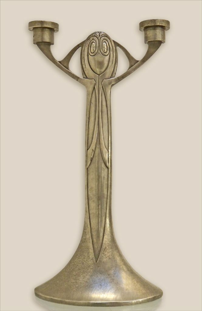 an art nouveau styled ss candle holder with two candles