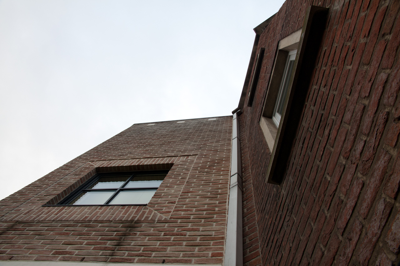 a large brick building with an open window on the side