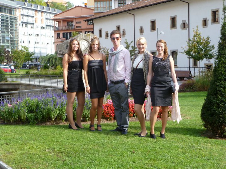 a group of people that are standing in the grass