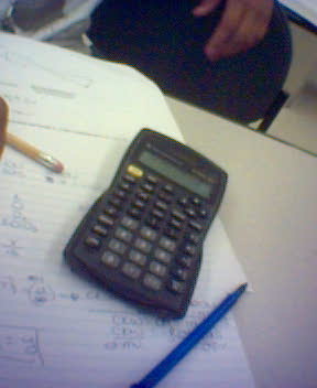 a calculator and pencil sitting on a paper with notes