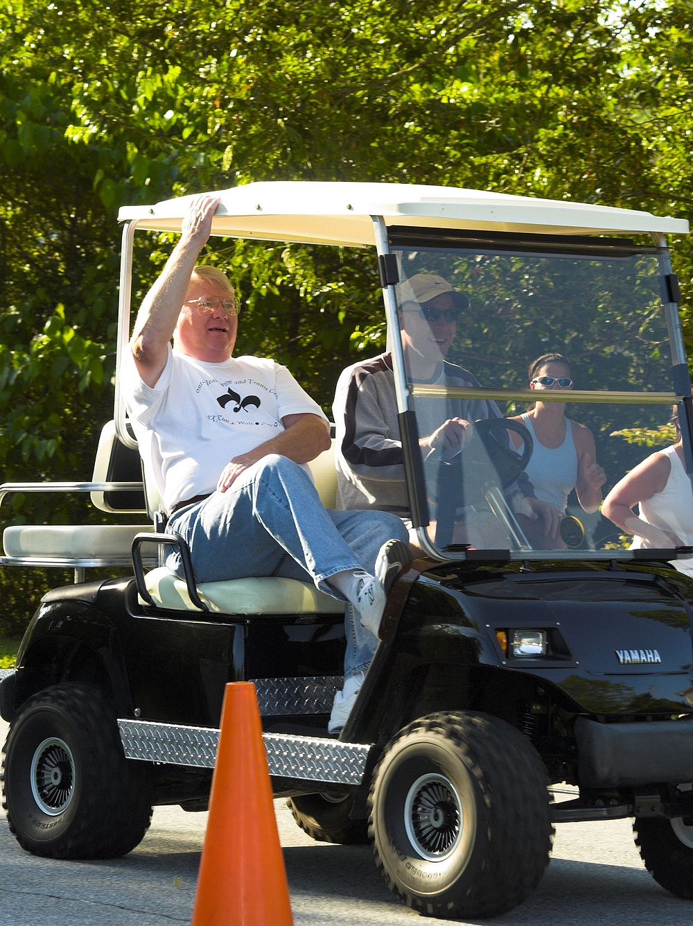 a man riding on the back of a golf cart