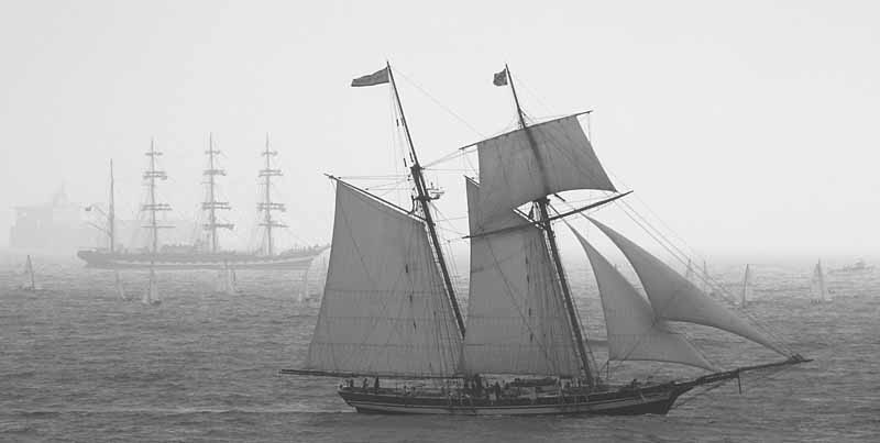 a black and white po of a three masted ship in the ocean