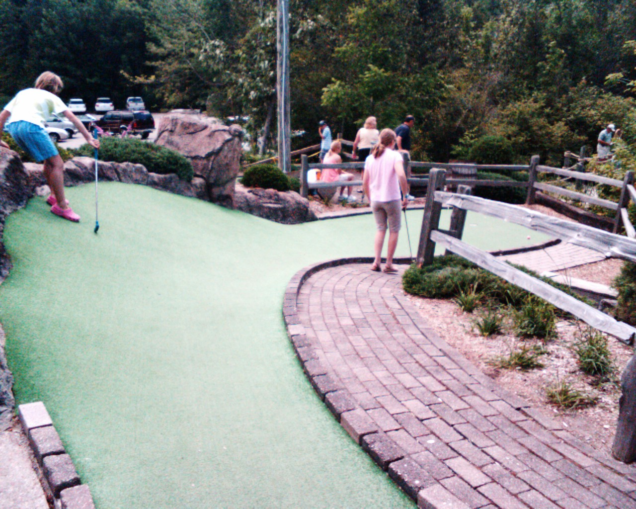 three people at the miniature golf course