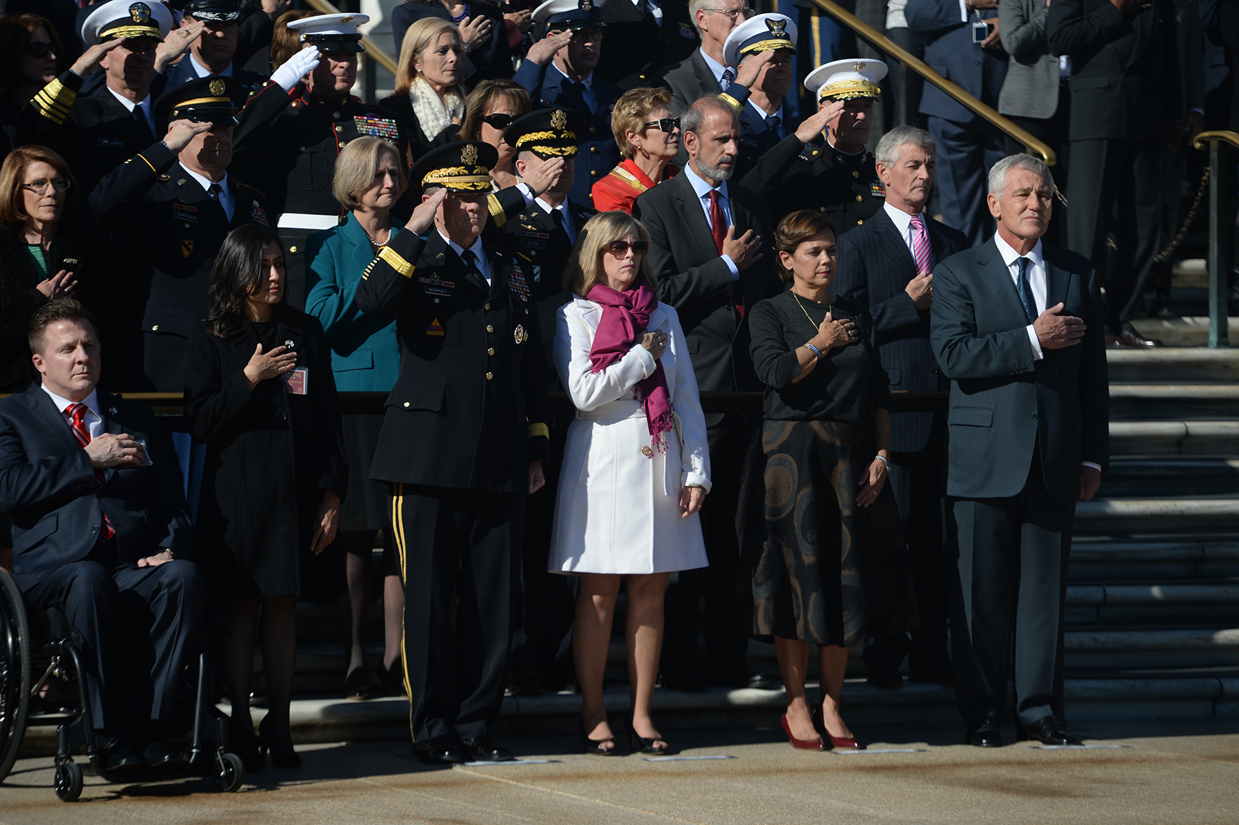 a woman in white dress taking pictures with some other people