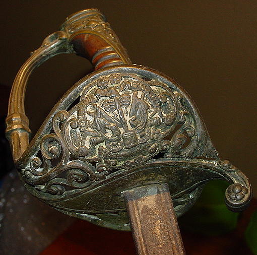 a bronze helmet shaped object with a handle