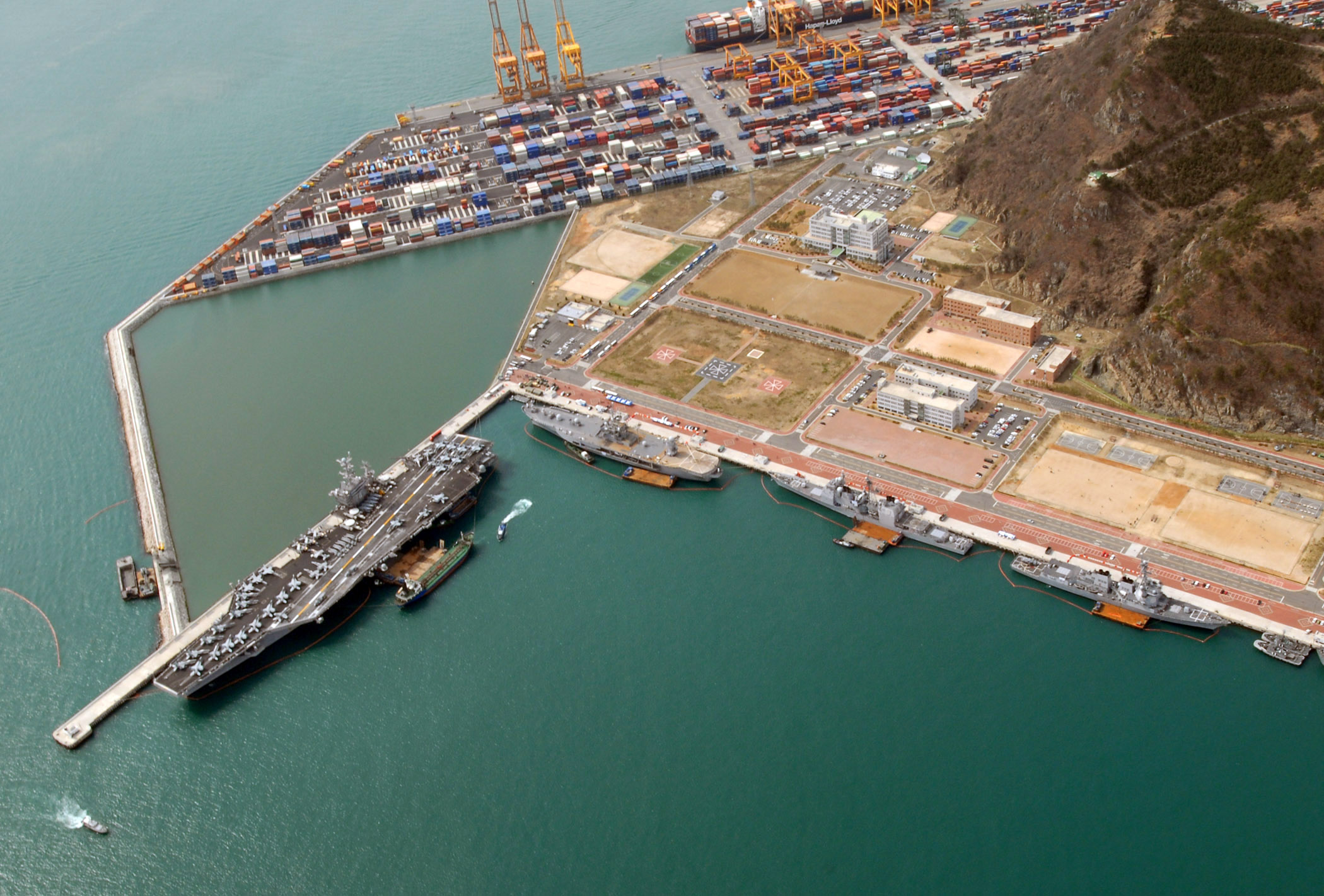 an aerial view of a large ship docked in the harbor