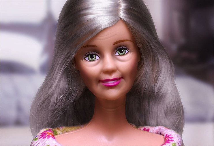 a doll with blonde hair wearing a pink dress