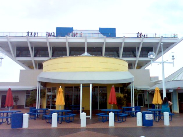 a building with several patio furniture and umbrellas outside
