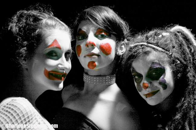 four female clowns posing for a black and white po