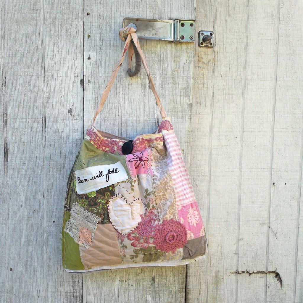 a purse hanging from the side of a white wooden wall