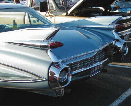 classic cars lined up with chrome tires
