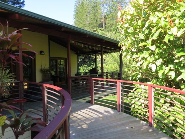 the deck on this house has wooden railings