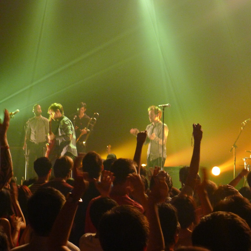 a group of people standing on top of a stage in front of a crowd