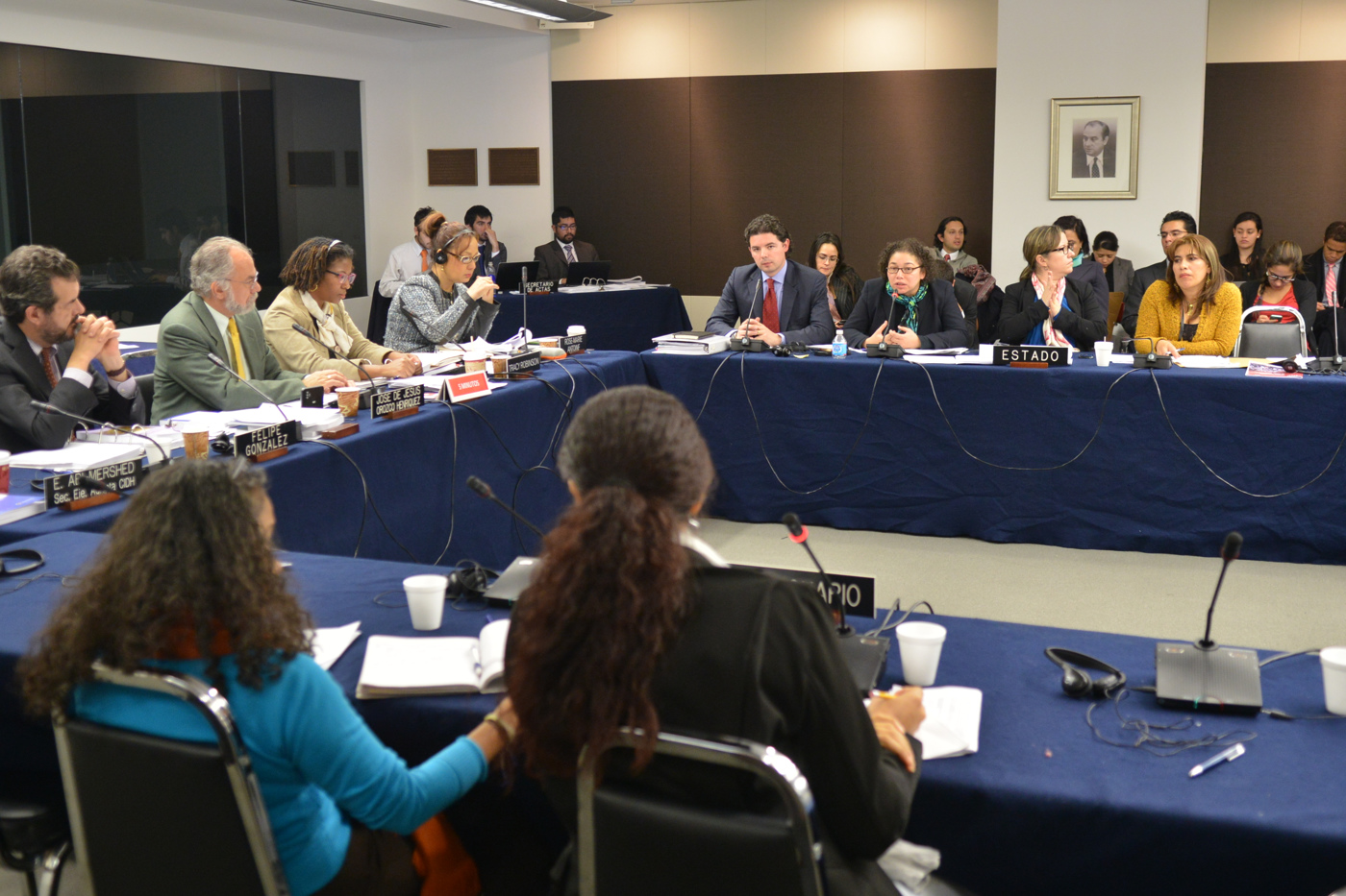 several people at a round table with water bottles